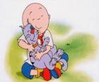 Caillou sedí na podlaze a objímat jeho kočka Gilbert