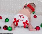 Dítě velmi Vánoce s plenka Santa Claus a různé barevné koule